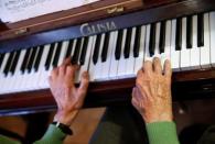 Pedro Rodriguez, 106, plays piano at home in Cangas de Onis, Asturias, in northern Spain, July 9, 2016. Rodriguez plays piano every day in the living room of the flat where he lives with his wife who is nearly 20 years younger than him. Their daughters visit them often. "The nuns taught me how to play the piano as a child," he says after giving a rendition ofÊa Spanish waltz. REUTERS/Andrea Comas