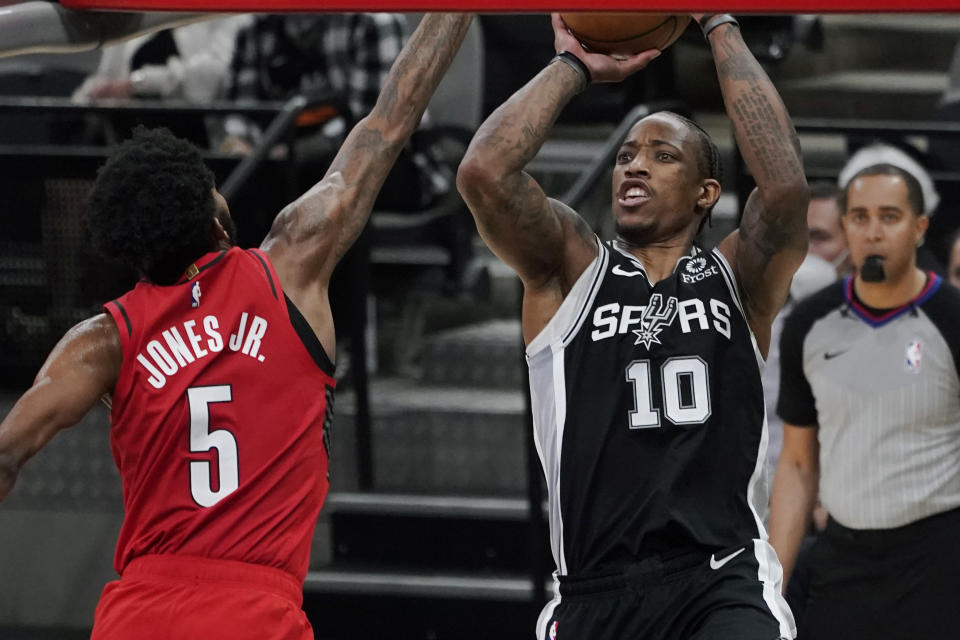 San Antonio Spurs forward DeMar DeRozan (10) shoot against Portland Trail Blazers forward Derrick Jones Jr. (5) during the first half of an NBA basketball game in San Antonio, Friday, April 16, 2021. (AP Photo/Eric Gay)