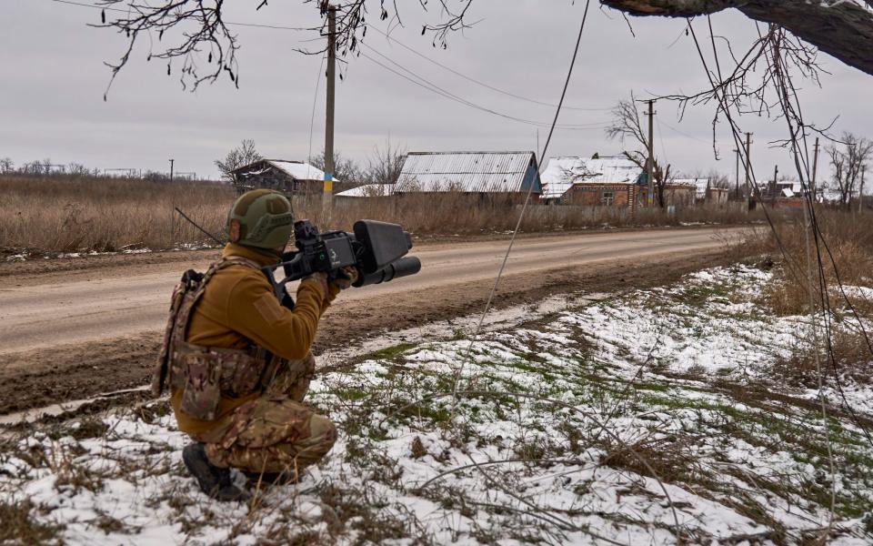 A Ukrainian soldier operates an anti-drone gun near Bakhmut