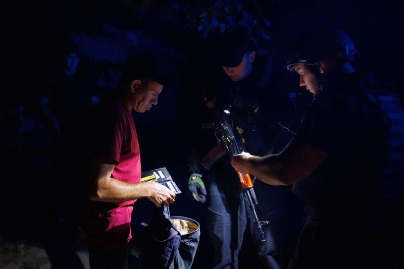 Ukrainian police officers patrol the city of Kramatorsk at night time