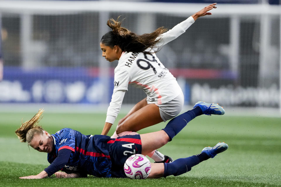 Angel City FC defender Madison Hammond (99) falls against OL Reign forward Veronica Latsko (24) during the first half of an NWSL quarterfinal playoff soccer match Friday, Oct. 20, 2023, in Seattle. (AP Photo/Lindsey Wasson)