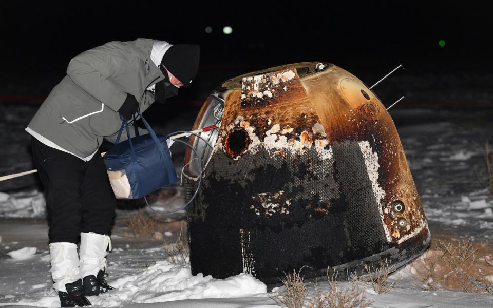 A researcher works next to Chang'e-5 lunar return capsule - Reuters