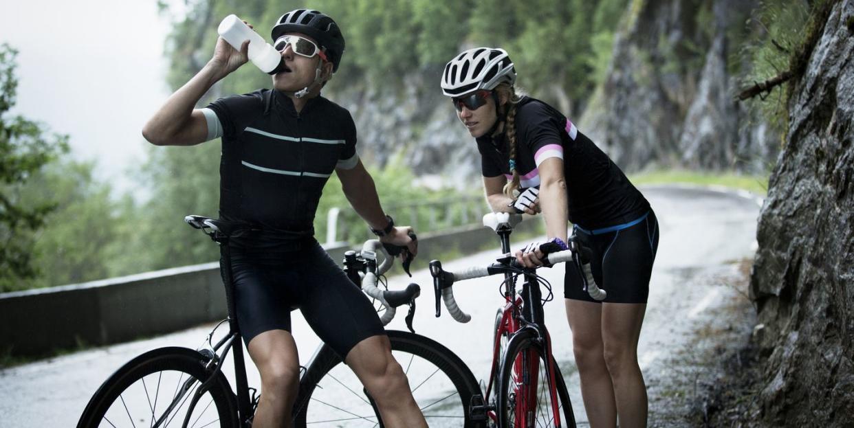 male and female race cyclists taking rest, low energy availability