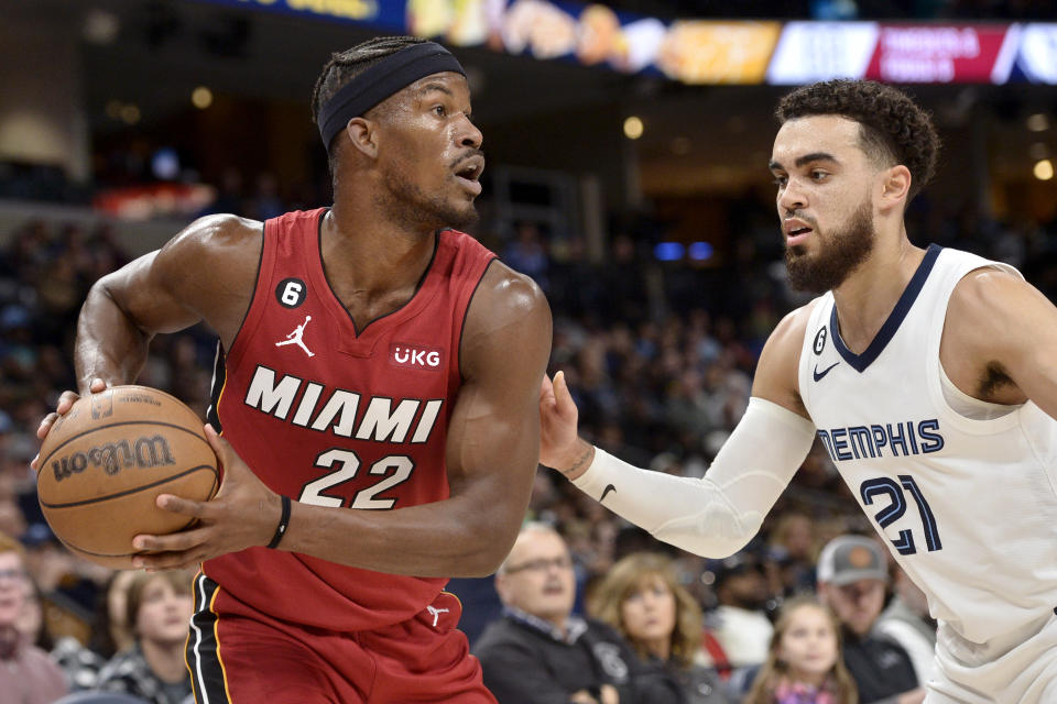 Miami Heat forward Jimmy Butler (22) handles the ball against Memphis Grizzlies guard Tyus Jones (21) in the second half of an NBA basketball game, Monday, Dec. 5, 2022, in Memphis, Tenn. (AP Photo/Brandon Dill)