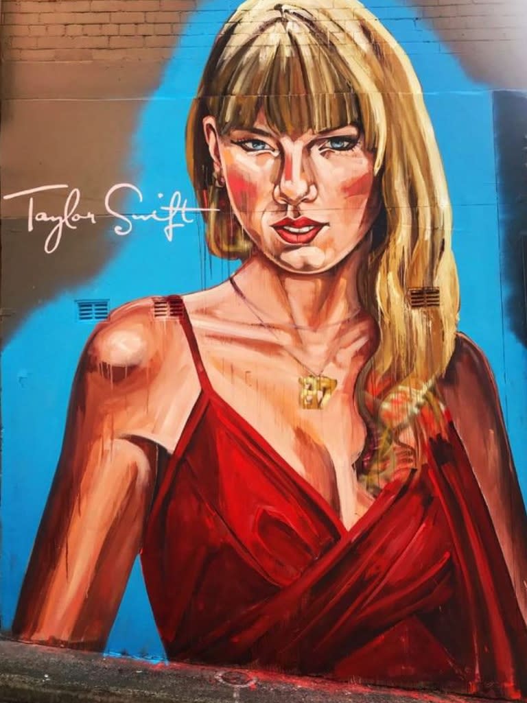 A huge Taylor Swift mural has popped up in Sydney ahead of her arrival for her three shows, but the artwork has received mixed reviews. The large portrait of Swift is on Crown Street in Surry Hills and portrays her wearing a red wrap dress, with her eyes angled downward. Picture: Instagram