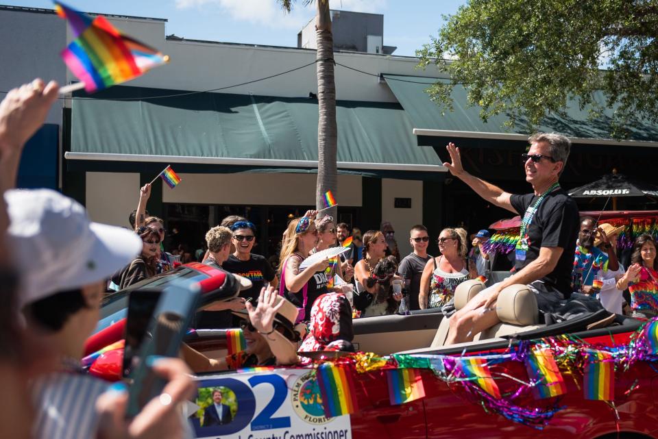 Palm Beach County Mayor Gregg Weiss waves to parade-goers during the Palm Beach Pride Parade on Sunday in Lake Worth Beach.