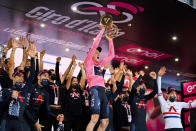 Britain’s Tao Geoghegan Hart holds aloft the trophy as he celebrates with teammates after winning the Giro d'Italia cycling race, in Milan, Italy, Sunday, Oct. 25, 2020. In one of the most exciting final stages of a Grand Tour, British rider Tao Geoghegan Hart won the Giro d’Italia on Sunday, edging out Australian Jai Hindley by just 39 seconds. (Marco Alpozzi/LaPresse via AP)