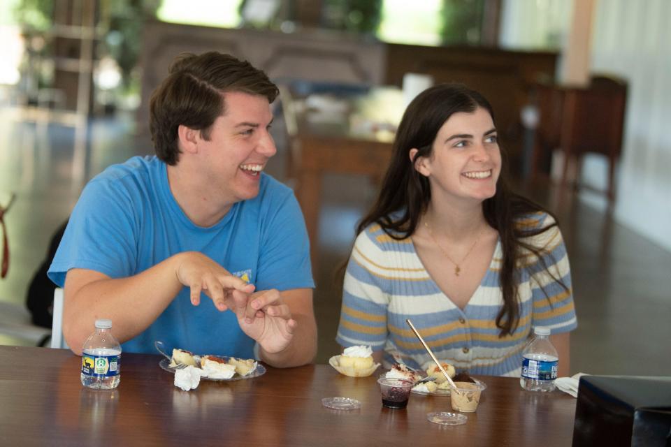 Jackson Graham and Shelby Guthrie taste cake samples at The Pavilion at Hunter Valley Farm alongside students from the University of Tennessee's Department of Retail, Hospitality and Tourism Management. Students are planning the couple's wedding as part of their course work.