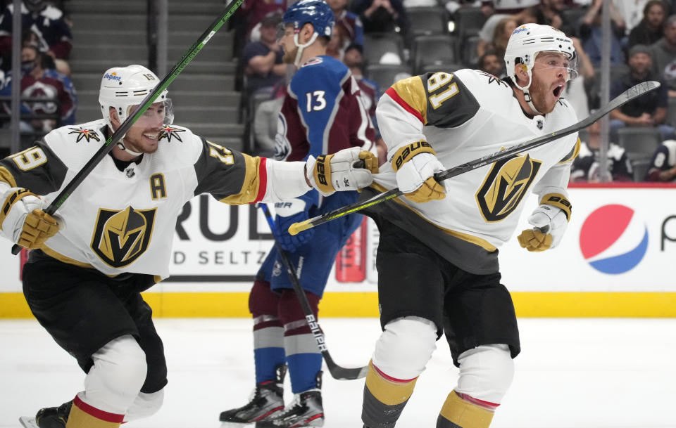 Vegas Golden Knights right wing Reilly Smith, left, celebrates with center Jonathan Marchessault, who scored the tying goal against the Colorado Avalanche during the third period of Game 5 of an NHL hockey Stanley Cup second-round playoff series Tuesday, June 8, 2021, in Denver. (AP Photo/David Zalubowski)