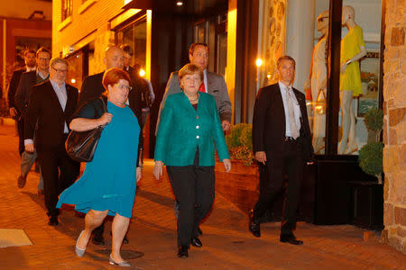 German Chancellor Angela Merkel walks back to her hotel after going out for a walk and dinner shortly after arriving in Washington, U.S., April 26, 2018. REUTERS/Brian Snyder