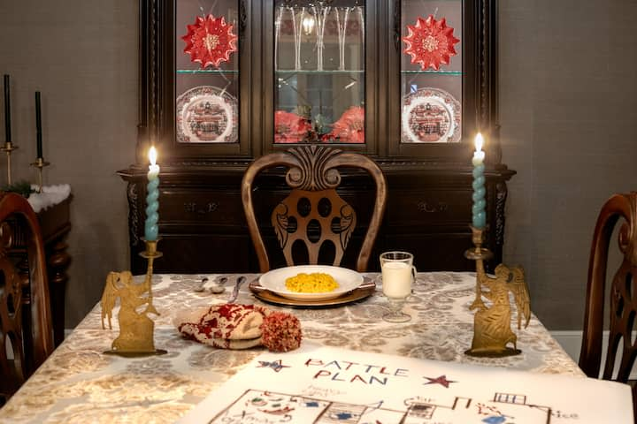 home alone house dining room table with two candles and bowl of macaroni and cheese