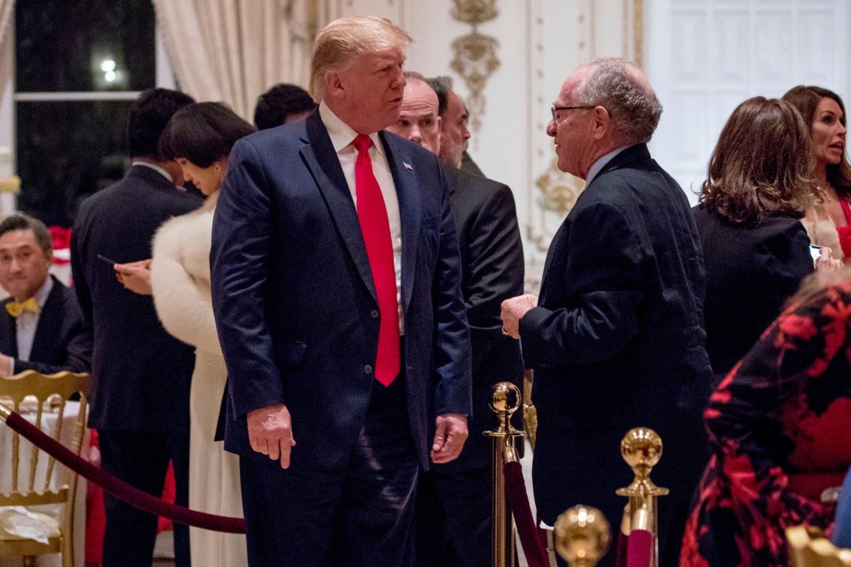 Donald Trump speaks to Alan Dershowitz as he arrives for a Christmas Eve dinner at Mar-a-Lago in Palm Beach, Florida, in 2019: AP
