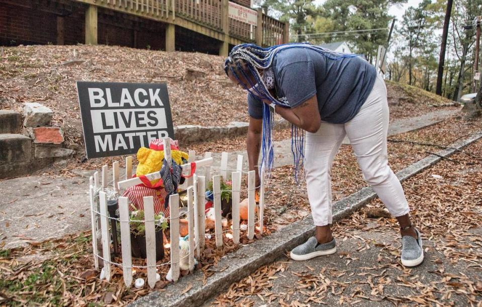 Lavern Lucier lights candles on November 9, 2020 at a memorial she created for her son, Syncere Burrell. Burrell was shot and killed where the memorial sits, near the corner of Lincoln St. and Linwood Ave. in Durham, N.C. on August 10, 2020. Julia Wall/jwall@newsobserver.com