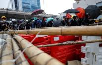 Demonstrators build barricades during a protest in Hong Kong