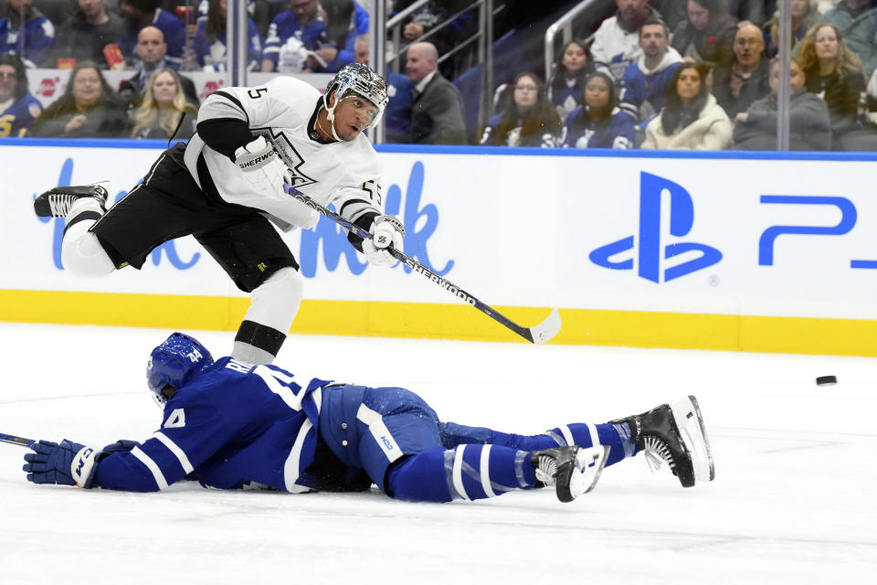 Los Angeles Kings' Quinton Byfield takes a shot as Toronto Maple Leafs' Morgan Rielly tries to defend during the first period of an NHL hockey game, Tuesday, Oct. 31, 2023 in Toronto. (Chris Young/The Canadian Press)