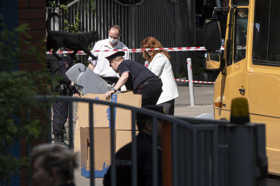 Police officers and investigators collect parts of a Ukrainian drone which reportedly damaged an apartment building in Moscow, Russia, Tuesday, May 30, 2023. In Moscow, residents reported hearing explosions and Mayor Sergei Sobyanin later confirmed there had been a drone attack that he said caused "insignificant" damage. (AP Photo)