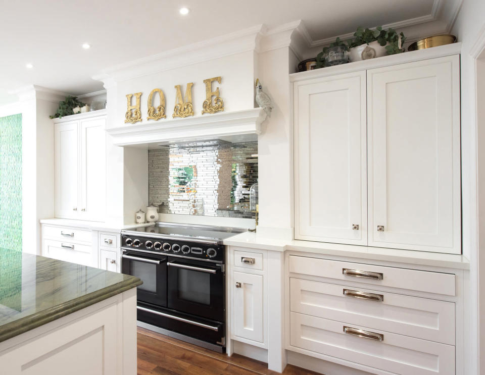 large kitchen with a huge sign that says Home above the stove