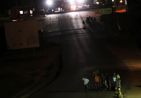 People walk to cross after the border with Venezuela was closed to vehicle traffic, seen from the Brazilian city of Pacaraima, Roraima state, Brazil February 21, 2019. REUTERS/Ricardo Moraes