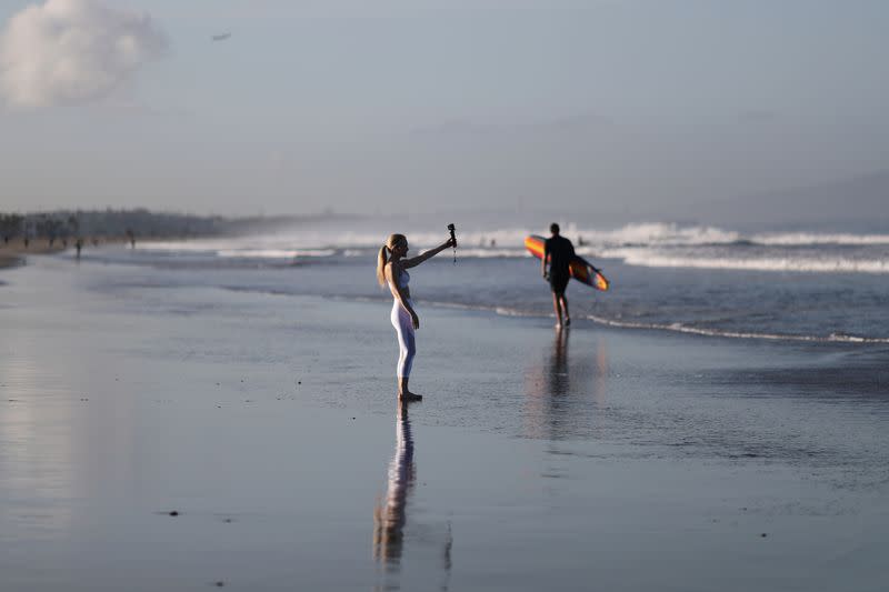 People walk on the beach on the first day of the opening of LA County beaches in Santa Monica