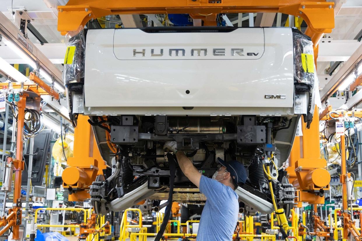 GM will welcome President Joe Biden to Factory ZERO on Wednesday, Nov. 17, 2021, as the company opens the doors to its all-electric assembly plant in Detroit and Hamtramck, Michigan. Here, a worker builds a 2022 GMC Hummer EV pickup.