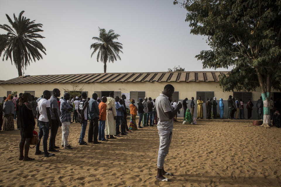 Senegalese voters line up to cast their votes at a polling station in Dakar, Senegal, Sunday Feb. 24, 2019. Voters are choosing whether to give President Macky Sall a second term in office as he faces four challengers. (AP Photo/Jane Hahn)