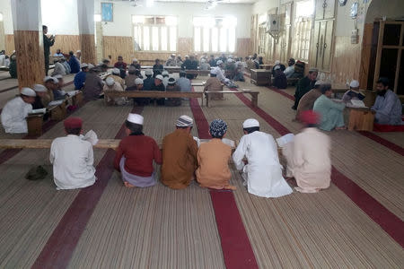 Students recite verses from the Koran at a madrasa situated near an impact site, after Indian military aircrafts struck on February 26, according to Pakistani officials, during a trip organised by the government, in Jaba village, near Balakot, Pakistan, April 10, 2019. REUTERS/Salahuddin