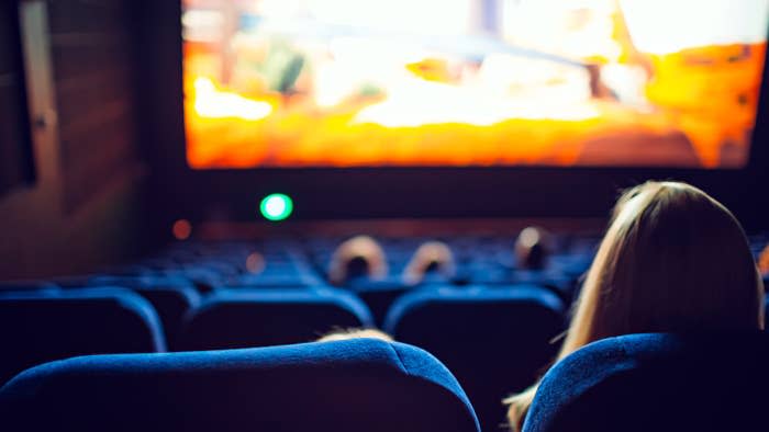 A person watching a movie at a theater