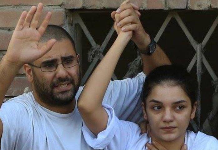 Egyptian pro-democracy activists Alaa Abd El Fattah, left, and his sister Sanaa Seif are seen in a 2014 file photo posted to Facebook by Seif. The photo was taken when their father, also a human rights activist, died. The siblings had been unable to visit their father in the hospital as they were both jailed at the time.  / Credit: Facebook/Sanaa Seif