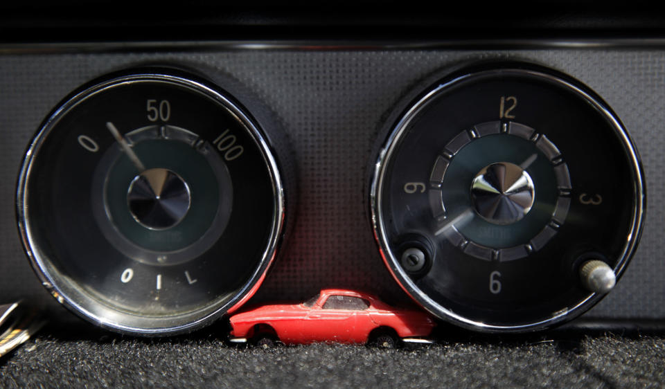 A miniature car rests on the dashboard of Irv Gordon's Volvo P1800 in Babylon, N.Y., Monday, July 2, 2012. Gordon's car already holds the world record for the highest recorded milage on a car and he is less than 40,000 miles away from passing three million miles on the Volvo.  (AP Photo/Seth Wenig)