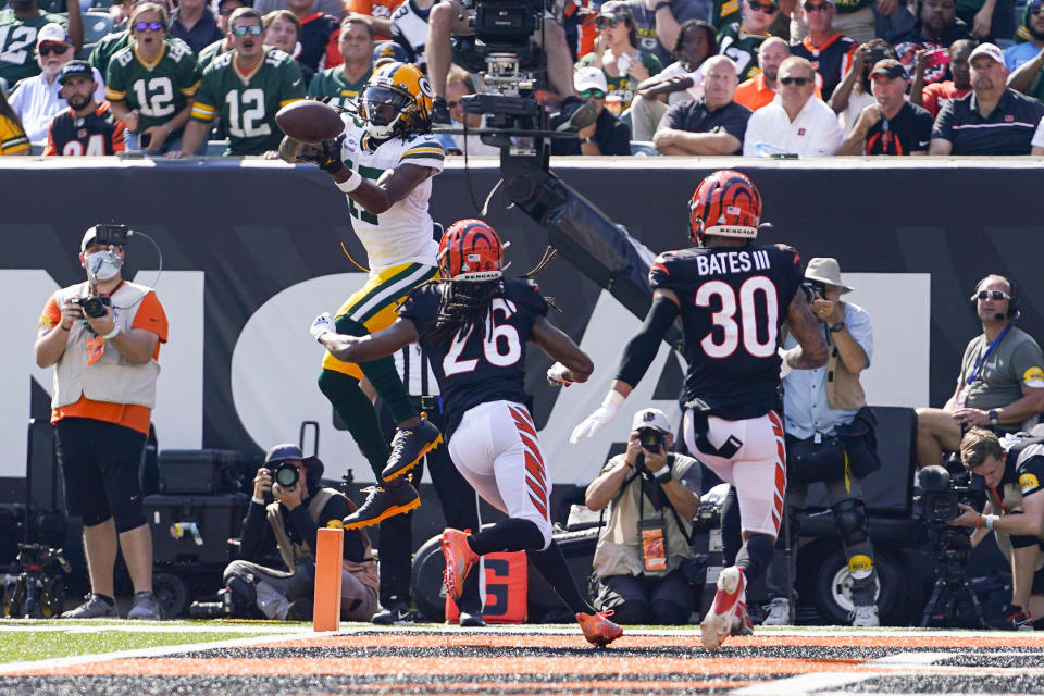 Green Bay Packers wide receiver Davante Adams (17) makes a catch over Cincinnati Bengals cornerback Trae Waynes (26) for a touchdown in the first half of an NFL football game in Cincinnati, Sunday, Oct. 10, 2021. (AP Photo/Bryan Woolston)