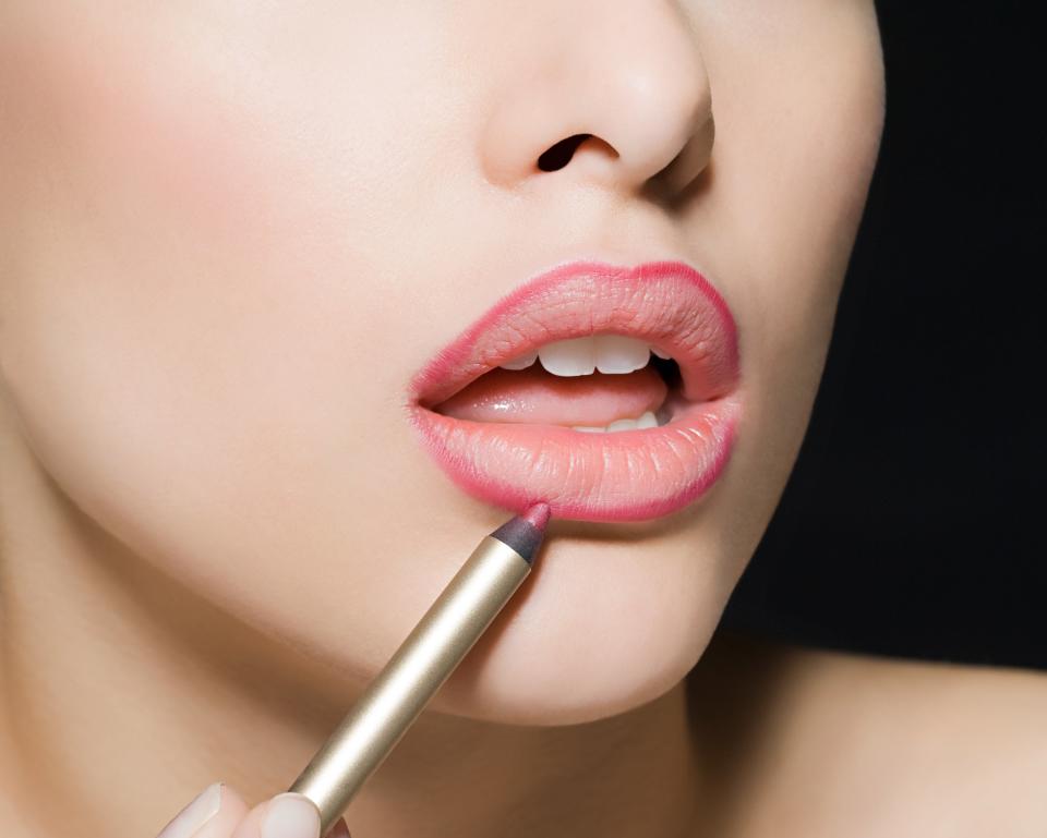 woman applying lip liner