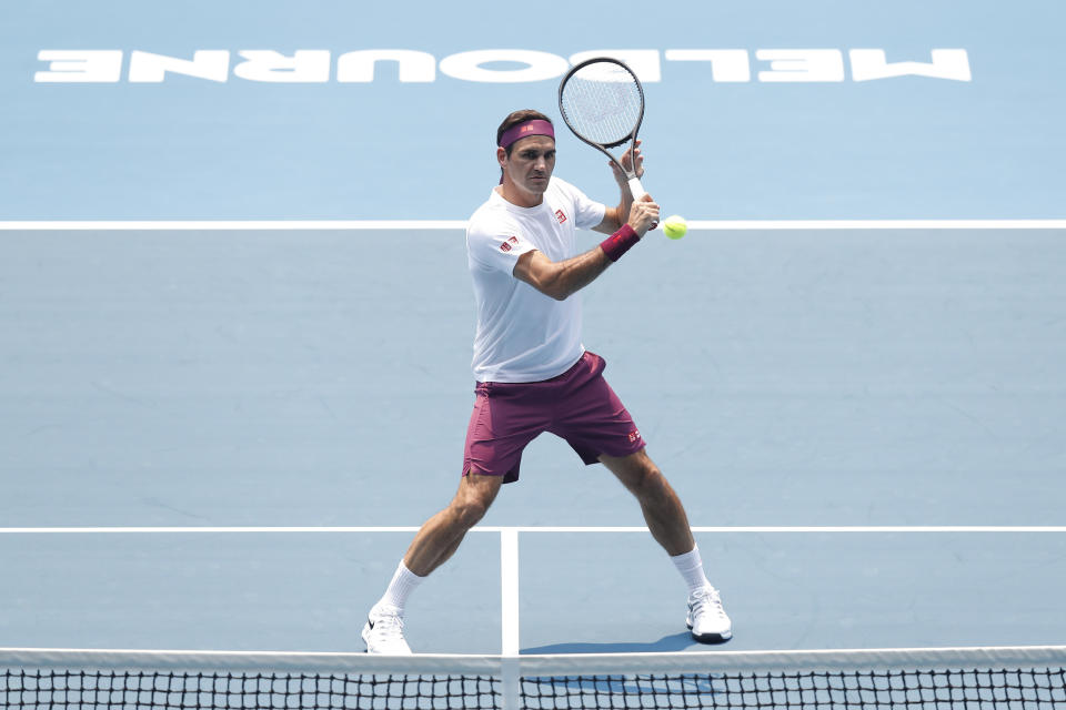 Roger Federer hitting a volley at Melbourne Park.