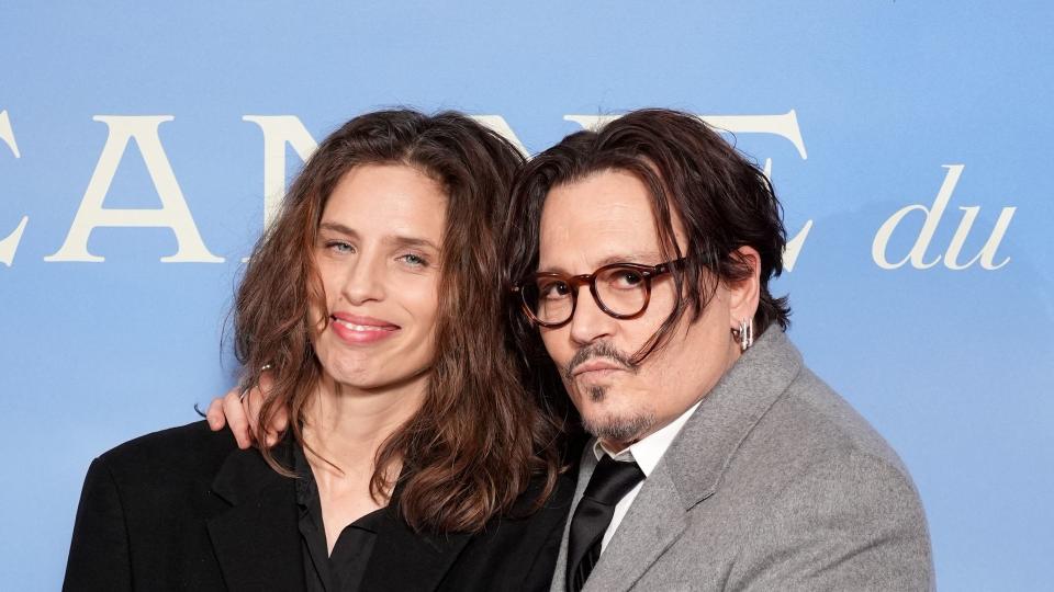 Maiwenn and Johnny Depp holding hands at premiere 