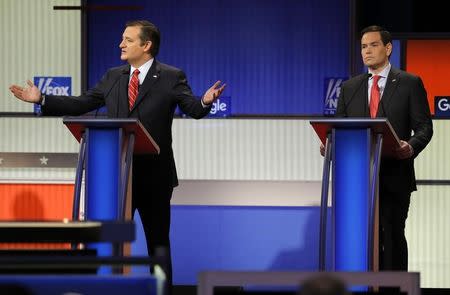 Republican U.S. presidential candidate Senator Ted Cruz (L) speaks as Senator Marco Rubio listens at the debate held by Fox News for the top 2016 U.S. Republican presidential candidates in Des Moines, Iowa January 28, 2016. REUTERS/Jim Young