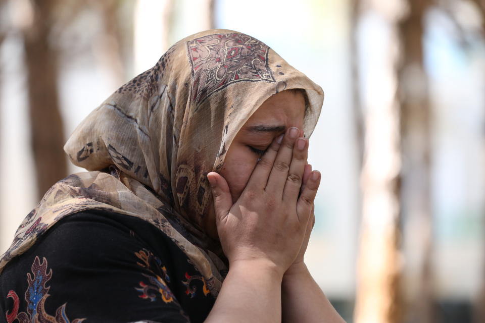 Ghazaal Habibyar, one of the 457 Afghan evacuees housed in Albania, wipes her eyes as she speaks during an interview with The Associated Press, Sunday, Aug. 29, 2021. Habibyar, an Afghan evacuee, is now housed in a tourist resort in Albania. But she can hardly rest when remembering the difficulties she and her family faced getting onto the plane and leaving her homeland. Fearing the Taliban in power and the future of her children, she decided to leave, pledging to her 6-year-old son that they would come back one day to help Afghanistan rebuild. (AP Photo/Franc Zhurda)