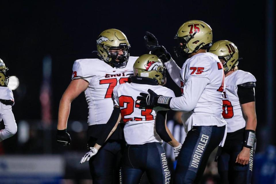 Mason Gauthier (23) celebrates a touchdown with his Bullitt East teammates during Friday night’s win in Lexington.