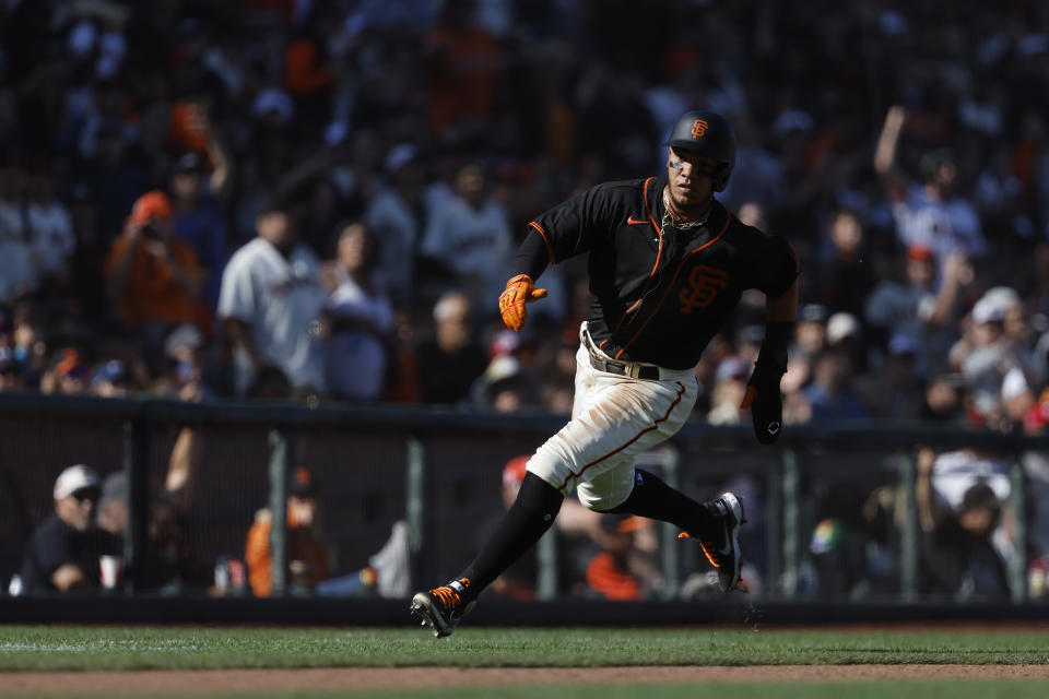 San Francisco Giants' Thairo Estrada runs home to score against the Cincinnati Reds during the fourth inning of a baseball game in San Francisco, Saturday, June 25, 2022. (AP Photo/Josie Lepe)