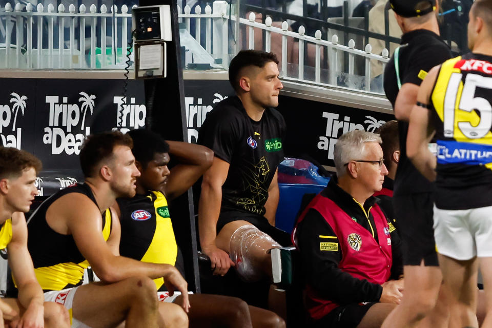 MELBOURNE, AUSTRALIA - MARCH 14: Dion Prestia of the Tigers is seen injured on the bench during the 2024 AFL Round 01 match between the Carlton Blues and the Richmond Tigers at the Melbourne Cricket Ground on March 14, 2024 in Melbourne, Australia. (Photo by Dylan Burns/AFL Photos via Getty Images)