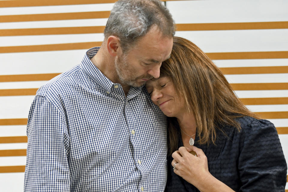 FILE - Simon and Sally Glass comfort each other during an emotional news conference in Denver on Tuesday, Sept. 13, 2022. They are calling for accountability after police shot and killed their 22-year-old son, Christian Glass, after he called 911 for roadside assistance in the Colorado mountain town of Silver Plume in June. The Glasses say their son was having a mental health episode and police needlessly escalated the situation. (AP Photo/Thomas Peipert, File)