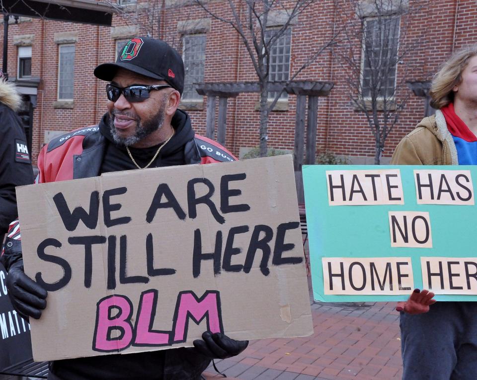 Lawrence Walker stands with a sign during one of the recent BLM demonstrations in downtown Wooster. The group has surpassed the 900 consecutive day mark.