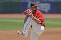 Cleveland Indians starting pitcher Carlos Carrasco winds up in the first inning in a baseball game against the Kansas City Royals, Sunday, July 26, 2020, in Cleveland. (AP Photo/Tony Dejak)