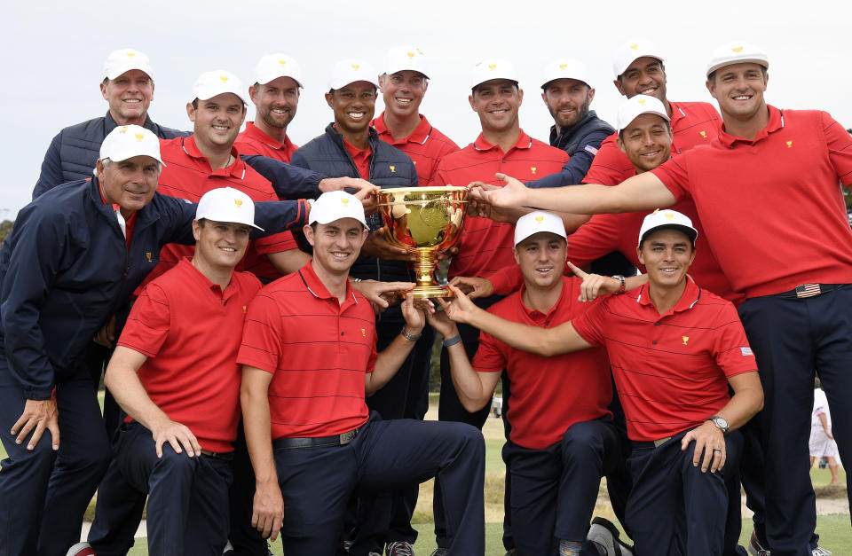 FILE - The U.S. team hold their trophy after they won the President's Cup golf tournament at Royal Melbourne Golf Club in Melbourne, Sunday, Dec. 15, 2019. The U.S. team won the tournament 16-14. The last Presidents Cup was so close the International team walked away with renewed hope that it had enough game and enough fight to conquer the mighty Americans. (AP Photo/Andy Brownbill, File)