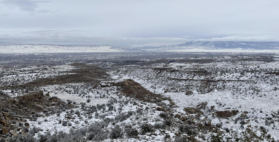 A light covering of snow brightens the open vista on Friday, Dec. 30, 2022, near Grand Junction, Colo. (AP Photo/Jesse Bedayn)