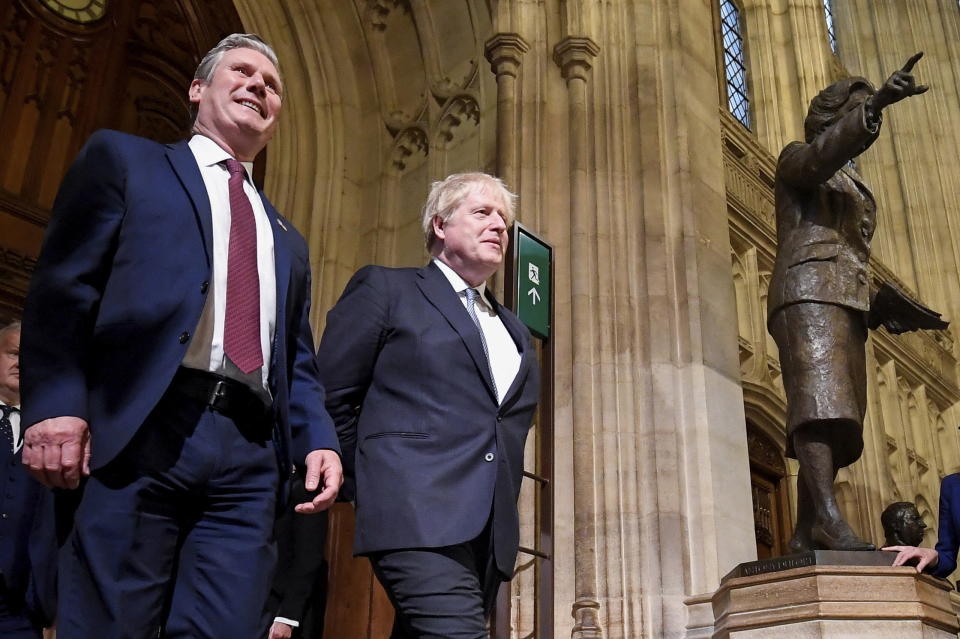 FILE - British Labour Party opposition leader Keir Starmer, left, and Britain's Prime Minister Boris Johnson pass a statue of former Prime Minister Margaret Thatcher as they walk through the Members' Lobby following the State Opening speech of Parliament at the Palace of Westminster in London, Tuesday, May 10, 2022. Toby Melville/Pool Photo via AP, File)