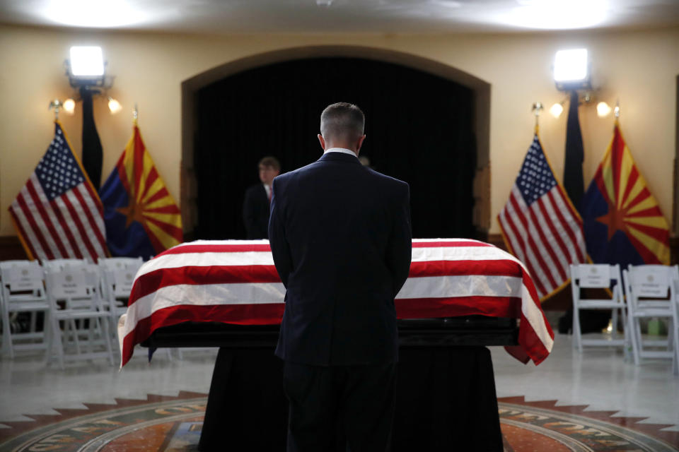 A guest pays their respects at the casket of Sen. John McCain, R-Ariz. during a memorial service at the Arizona Capitol on Wednesday, Aug. 29, 2018, in Phoenix. (AP Photo/Jae C. Hong, Pool)