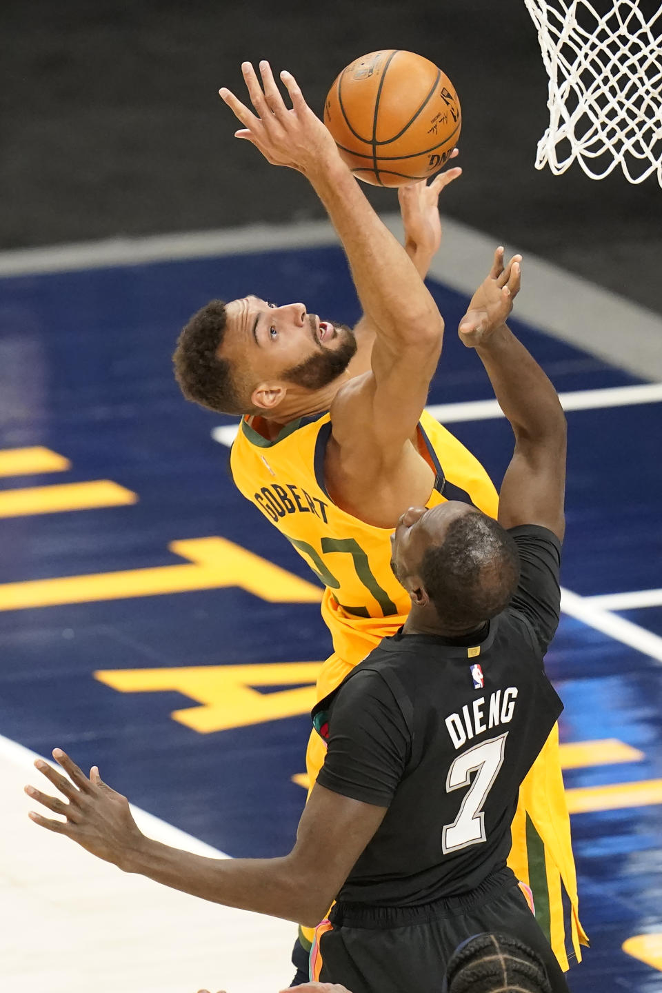 Utah Jazz center Rudy Gobert (27) and San Antonio Spurs center Gorgui Dieng (7) battle for a rebound in the first half during an NBA basketball game Monday, May 3, 2021, in Salt Lake City. (AP Photo/Rick Bowmer)