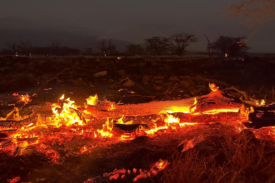 A wildfire burns in Kihei, Hawaii, late on Wednesday 9 August (AP)