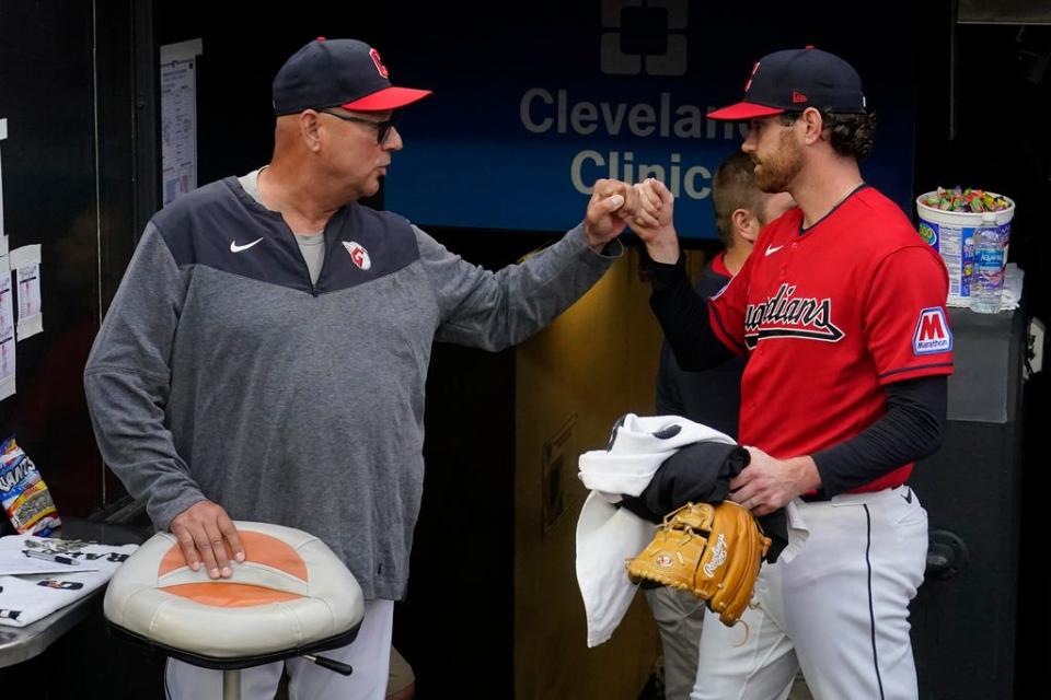 Cleveland Guardians manager Terry Francona, left, bumps fists with starting pitcher Shane Bieber, right, before the team's game against the Cincinnati Reds on Wednesday in Cleveland.