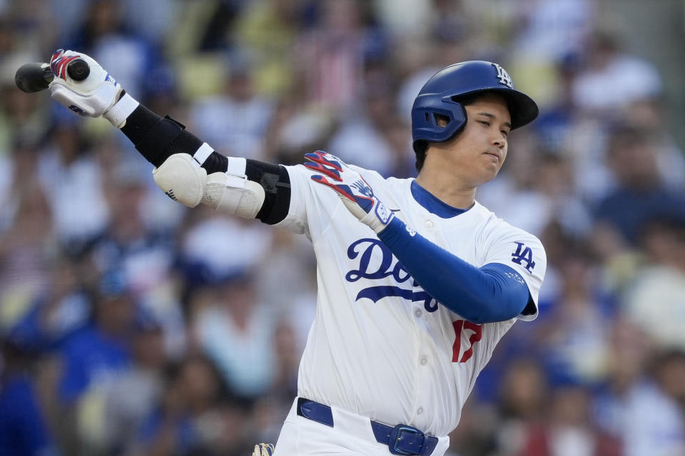 Los Angeles Dodgers designated hitter Shohei Ohtani strikes out swinging during the third inning of a baseball game against the Arizona Diamondbacks, Thursday, July 4, 2024, in Los Angeles. (AP Photo/Ryan Sun)