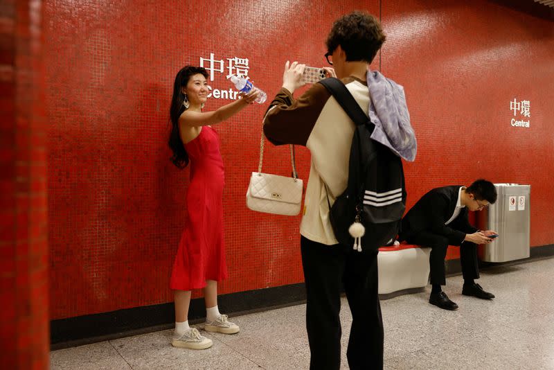 Laura Li, 28, poses for photos, a day ahead of the Chinese Labour Day 'Golden Week' holidays, in Hong Kong